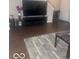 This living room features modern floors, a television, and a neutral color scheme at 6548 Frankenberger Dr, Indianapolis, IN 46237