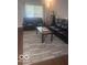 Living room featuring modern floors, a grey area rug, and comfortable seating at 6548 Frankenberger Dr, Indianapolis, IN 46237