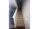 Carpeted stairway with white railings leads to the upper level of the home at 6548 Frankenberger Dr, Indianapolis, IN 46237