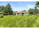 Lush backyard with green grass and siding of house at 6623 Lakeknoll Dr, Indianapolis, IN 46220