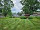 Spacious backyard featuring a lush lawn, privacy fence and shed perfect for outdoor enjoyment at 6623 Lakeknoll Dr, Indianapolis, IN 46220