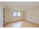 This bedroom features a window, light hardwood floors, and neutral walls at 6623 Lakeknoll Dr, Indianapolis, IN 46220