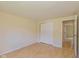 This bedroom features a door to the hall, bi-fold doors, and light hardwood floors at 6623 Lakeknoll Dr, Indianapolis, IN 46220