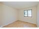 This bedroom features a window, light hardwood floors, and neutral walls at 6623 Lakeknoll Dr, Indianapolis, IN 46220