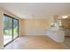 Bright dining area with sliding glass doors, breakfast bar and hardwood floors at 6623 Lakeknoll Dr, Indianapolis, IN 46220