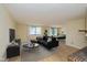 Modern living room featuring a comfortable sofa, coffee tables, and a dining area at 6623 Lakeknoll Dr, Indianapolis, IN 46220