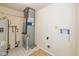 This utility room features a water heater, furnace, and hookups for a washer and dryer at 6623 Lakeknoll Dr, Indianapolis, IN 46220