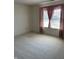 The bedroom includes soft carpet, neutral walls, and a window draped with light curtains at 7259 Registry Dr, Indianapolis, IN 46217