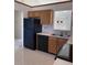 Kitchen with modern appliances and cabinets, tiled floor and view into the living space at 7259 Registry Dr, Indianapolis, IN 46217