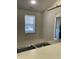 Bright kitchenette featuring a window and a view into the dining and living areas at 7259 Registry Dr, Indianapolis, IN 46217