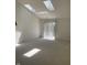 Bright sunlit room with skylights, light carpet and a sliding glass door to the backyard at 7259 Registry Dr, Indianapolis, IN 46217