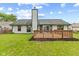 Backyard view highlighting the wooden deck, well-maintained lawn, and the home's exterior siding at 7384 Southern Lakes Dr, Indianapolis, IN 46237