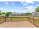 View from a wooden deck overlooking a fenced backyard, shed, and neighborhood homes, under a partly cloudy sky at 7384 Southern Lakes Dr, Indianapolis, IN 46237