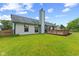 Spacious backyard with a well-kept lawn, wooden fence, and deck, presenting an inviting outdoor space at 7384 Southern Lakes Dr, Indianapolis, IN 46237