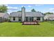 Spacious backyard with a wooden deck, perfect for outdoor entertaining, and lush green grass at 7384 Southern Lakes Dr, Indianapolis, IN 46237