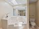 Bright bathroom featuring a soaking tub, skylight, and toilet at 7384 Southern Lakes Dr, Indianapolis, IN 46237