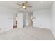 Carpeted bedroom with a ceiling fan and doorways leading to other areas of the home at 7384 Southern Lakes Dr, Indianapolis, IN 46237
