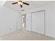 A bright bedroom features plush carpeting, ceiling fan, closet and neutral paint palette at 7384 Southern Lakes Dr, Indianapolis, IN 46237