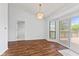 Dining area with wood flooring, a chandelier, and sliding doors to the deck at 7384 Southern Lakes Dr, Indianapolis, IN 46237