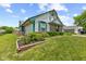 Beautiful exterior view of a home with flowerbeds and a lush green lawn, creating a welcoming curb appeal at 7384 Southern Lakes Dr, Indianapolis, IN 46237