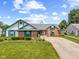 Charming single-story home with a brick and vinyl exterior, well-manicured lawn, and a curved driveway at 7384 Southern Lakes Dr, Indianapolis, IN 46237