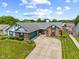 Beautiful single-story home featuring a brick and vinyl exterior, manicured lawn, and a curved driveway leading to a garage at 7384 Southern Lakes Dr, Indianapolis, IN 46237