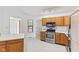 A kitchen with stainless steel appliances, laminate countertops, and wood cabinetry at 7384 Southern Lakes Dr, Indianapolis, IN 46237