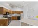 Eat-in kitchen featuring wood cabinetry, recessed lighting, laminate countertops and white appliances at 7384 Southern Lakes Dr, Indianapolis, IN 46237
