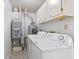 A laundry room features a washer, dryer, water heater and utility sink at 7384 Southern Lakes Dr, Indianapolis, IN 46237