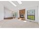 Spacious living room features a fireplace, skylights and sliding doors to the deck at 7384 Southern Lakes Dr, Indianapolis, IN 46237
