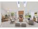 Bright living room boasting a brick fireplace, skylights, and open access to the dining area at 7384 Southern Lakes Dr, Indianapolis, IN 46237