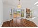 Open-concept living area with wood floors, a fireplace, and sliding doors to the deck at 7384 Southern Lakes Dr, Indianapolis, IN 46237