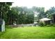 Expansive backyard featuring a lush lawn, garden beds, a shed, and outdoor seating for relaxation at 7780 Cree Trl, Indianapolis, IN 46250