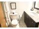 Modern bathroom with white marble countertops, dark wood cabinetry, and neutral-toned tile flooring at 7780 Cree Trl, Indianapolis, IN 46250