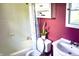 Cozy bathroom with a tub, tile surround, and natural light from a window at 7780 Cree Trl, Indianapolis, IN 46250