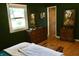 Stylish bedroom featuring wood furniture, a bright window, and hardwood flooring at 7780 Cree Trl, Indianapolis, IN 46250