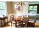 Inviting dining area featuring a classic chandelier and view into another living space at 7780 Cree Trl, Indianapolis, IN 46250