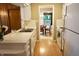 Bright kitchen with white cabinetry, countertops, and appliances, open to the dining area at 7780 Cree Trl, Indianapolis, IN 46250