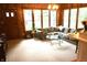 Cozy living room featuring wood paneling, a comfortable couch, and large windows providing natural light at 7780 Cree Trl, Indianapolis, IN 46250