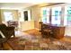 Inviting living room with hardwood floors, a large window, and an elegant writing desk at 7780 Cree Trl, Indianapolis, IN 46250