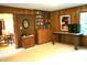Bright Living room with wood paneling, an adjacent dining room, and a built-in bookshelf at 7780 Cree Trl, Indianapolis, IN 46250