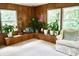 Bright, wood-paneled sunroom with white carpet, couch, potted plants, and great natural light from the windows at 7780 Cree Trl, Indianapolis, IN 46250