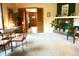 Warm living room featuring a brick fireplace and view into another room at 7780 Cree Trl, Indianapolis, IN 46250