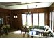 Warm living room with wood paneling, an inviting couch, and a view from the kitchen bar at 7780 Cree Trl, Indianapolis, IN 46250