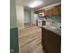 Functional kitchen with white appliances, wood cabinets, and laminate countertops and floors at 8092 Crystal Ct, Avon, IN 46123