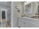 Elegant bathroom featuring a white vanity with stone countertops and a decorative mirror at 847 E Jefferson St, Franklin, IN 46131