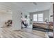 Bright, open bedroom with a comfortable bed, a gaming chair, and easy access to the living room at 847 E Jefferson St, Franklin, IN 46131