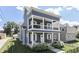 Charming home with double porches has beautiful landscaping, white pillars, and a porch swing at 847 E Jefferson St, Franklin, IN 46131