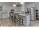 Modern kitchen with white cabinets, stainless appliances, island with seating, and stylish light fixtures at 847 E Jefferson St, Franklin, IN 46131