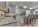 Bright kitchen boasts stainless appliances, granite counters, island, and open concept layout for modern living at 847 E Jefferson St, Franklin, IN 46131